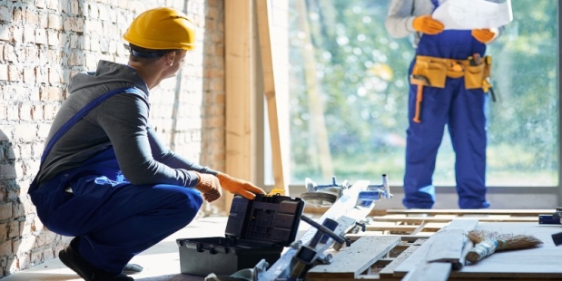 A person in hardhats looking at a toolbox AI-generated content may be incorrect.
